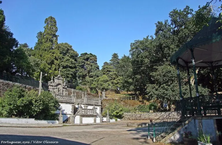 Adro do Santuário de Nossa Senhora das Preces, em Vale de Maceira, com a escadaria barroca, o coreto e as árvores do jardim